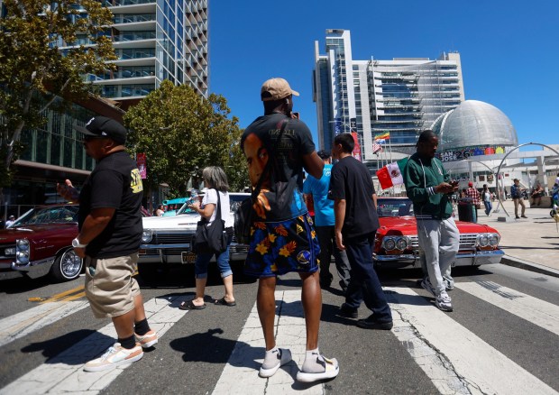 People look at cars on display at the fourth annual San Jose Lowrider Day along East Santa Clara Street in front of San José City Hall in downtown San José, Calif., on Sunday, Sept. 6, 2026. (Nhat V. Meyer/Bay Area News Group)