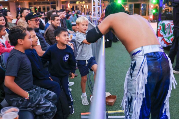 Fans react as luchador Kid Destino recovers outside the ring during Lucha Libre Wrestling Night at Thrive City Plaza in San Francisco, Calif., Thursday, Sept. 24, 2026. Twenty-two wrestlers performed in six matches during the free event hosted by West Coast Pro Wrestling and Pro Wrestling Revolution. (Ray Chavez/Bay Area News Group)