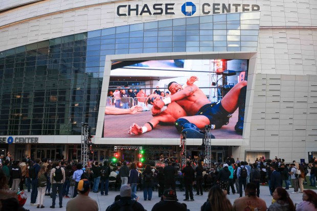 Fans watch luchadores perform on the video board during Lucha Libre Wrestling Night at Thrive City Plaza in San Francisco, Calif., Thursday, Sept. 24, 2026. Twenty-two wrestlers performed in six matches during the free event hosted by West Coast Pro Wrestling and Pro Wrestling Revolution. (Ray Chavez/Bay Area News Group)