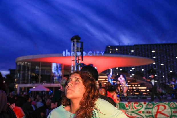 Fans watch luchadores perform on the video board during Lucha Libre Wrestling Night at Thrive City Plaza in San Francisco, Calif., Thursday, Sept. 24, 2026. Twenty-two wrestlers performed in six matches during the free event hosted by West Coast Pro Wrestling and Pro Wrestling Revolution. (Ray Chavez/Bay Area News Group)