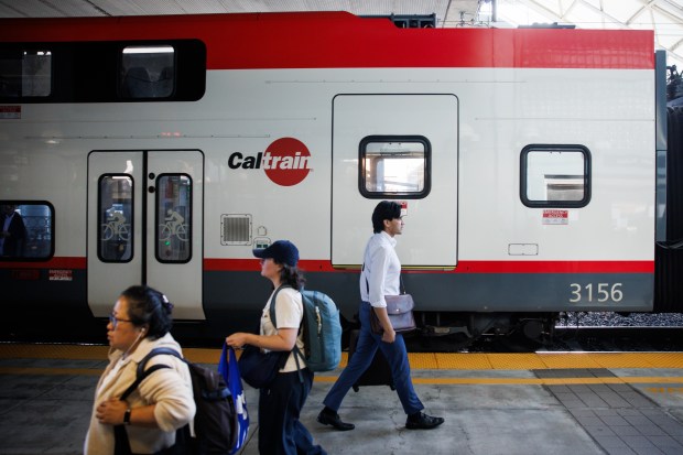 Passengers walk by a Caltrain train at Millbrae Station on Sept. 17, 2026, in Millbrae, Calif. (Dai Sugano/Bay Area News Group)