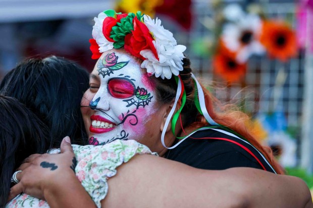 Makeup artist Rosa Arismendiz, of San Jose, exchanges a hug with an attendee during the 216th anniversary of Mexican Independence Day celebrations at San Jose City Hall in San Jose, Calif., on Tuesday, Sept. 15, 2026. Hundreds of people gathered for "El Grito," or "The Cry," which was delivered by Consul General of Mexico in San Jose, Neftali Said Pérez González, alongside San Jose Mayor Matt Mahan. (Ray Chavez/Bay Area News Group)