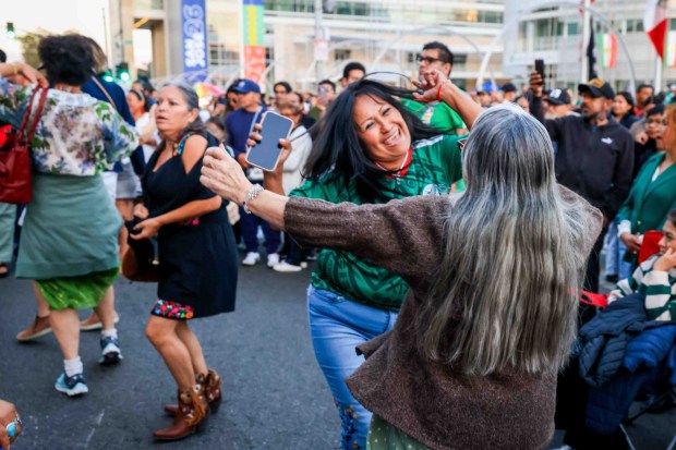 Hundreds of attendees dressed in patriotic colors and costumes dance Mexican music before "El Grito," or "The Cry," which would be delivered by Consul General Neftali Said Pérez González during the 216th anniversary of Mexican Independence Day celebrations at San Jose City Hall in San Jose, Calif., on Tuesday, Sept. 15, 2026. (Ray Chavez/Bay Area News Group)