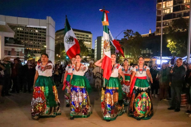 A color guard composed of staff members from the Consulate General of Mexico in San Jose make their way to deliver the Mexican flag to Consul General Neftali Said Pérez González at San Jose City Hall in San Jose, Calif., on Tuesday, Sept. 15, 2026. Hundreds of attendees dressed in patriotic colors and costumes gathered for "El Grito," or "The Cry," which was announced by the consul general alongside San Jose Mayor Matt Mahan. (Ray Chavez/Bay Area News Group)