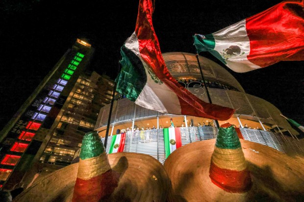 Alvaro Cortez, left, and Fernando Robles, of San Jose, wave the Mexican flags as Consul General Neftali Said Pérez González delivers "El Grito," or "The Cry," during 216th anniversary Mexican Independence Day celebrations at San Jose City Hall in San Jose, Calif., on Tuesday, Sept. 15, 2026. (Ray Chavez/Bay Area News Group)