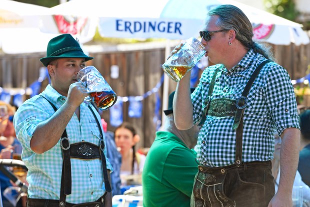 Celebrants dressed in lederhosen hoist their steins at one of the Speisekammer restaurant events in Alameda. (Jose Carlos Fajardo/Bay Area News Group)