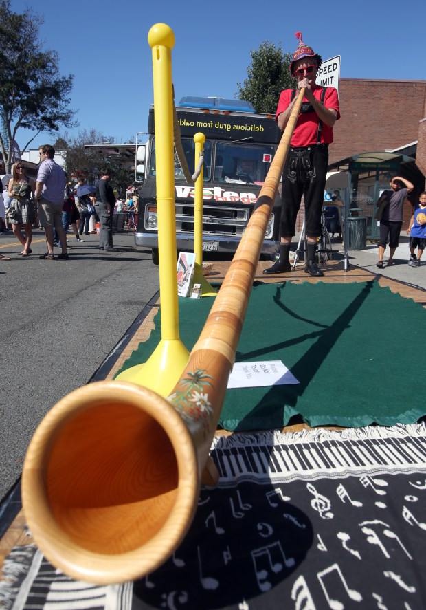 A musician plays the alphorn during the Oaktoberfest in Oakland's Dimond neighborhood. This year's celebration and street fair is planned for Oct. 3-4. (Jane Tyska/Bay Area News Group)