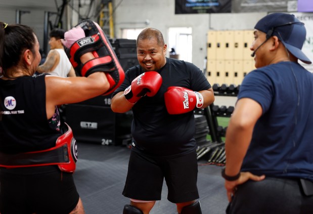 Head Coach Ed Carpio, far right, observes Michael Galiza, center, and Amanda Hernandez, both from San Jose, during the Muay Thai Pad Work class at Condition and Competition Kickboxing, also known as Team CCK, in San Jose, Calif., on Tuesday, Sept. 1, 2026. (Nhat V. Meyer/Bay Area News Group)