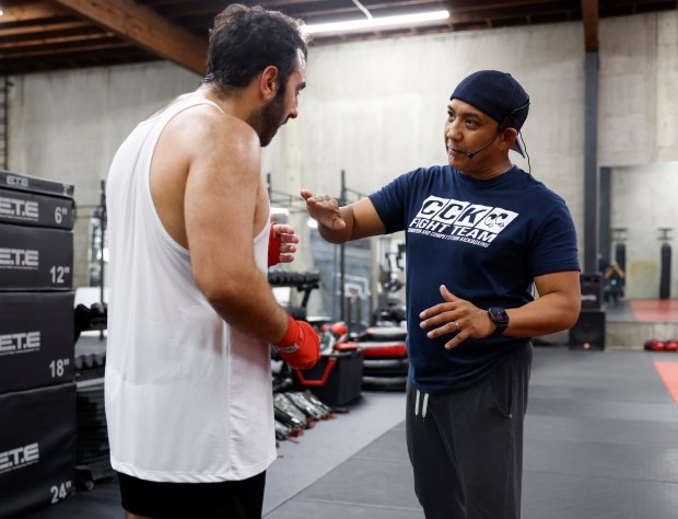 Head Coach Ed Carpio talks kicking techniques with Sepehr Raissian, from San Jose, during the Muay Thai Pad Work class at Condition and Competition Kickboxing, also known as Team CCK, in San Jose, Calif., on Tuesday, Sept. 1, 2026. (Nhat V. Meyer/Bay Area News Group)