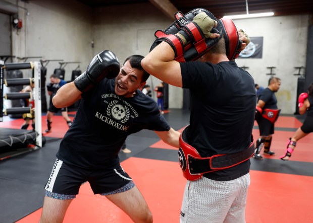 Alex "AP" Pasos, left, punches Reid Rokitta, both from San Jose, during the Muay Thai Pad Work class at Condition and Competition Kickboxing, also known as Team CCK, in San Jose, Calif., on Tuesday, Sept. 1, 2026. (Nhat V. Meyer/Bay Area News Group)