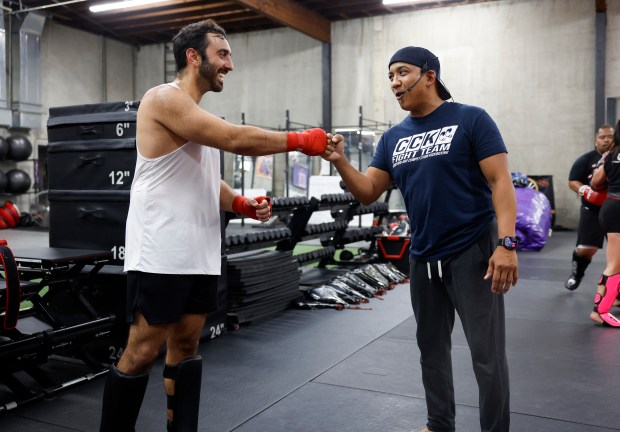 Head Coach Ed Carpio fist bumps Sepehr Raissian, from San Jose, during the Muay Thai Pad Work class at Condition and Competition Kickboxing, also known as Team CCK, in San Jose, Calif., on Tuesday, Sept. 1, 2026. (Nhat V. Meyer/Bay Area News Group)