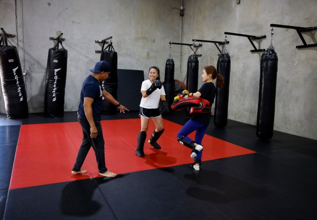 Head Coach Ed Carpio coaches Sheryl Amparo, center, and Jennifer Lee, both from San Jose, during the Muay Thai Pad Work class at Condition and Competition Kickboxing, also known as Team CCK, in San Jose, Calif., on Tuesday, Sept. 1, 2026. (Nhat V. Meyer/Bay Area News Group)