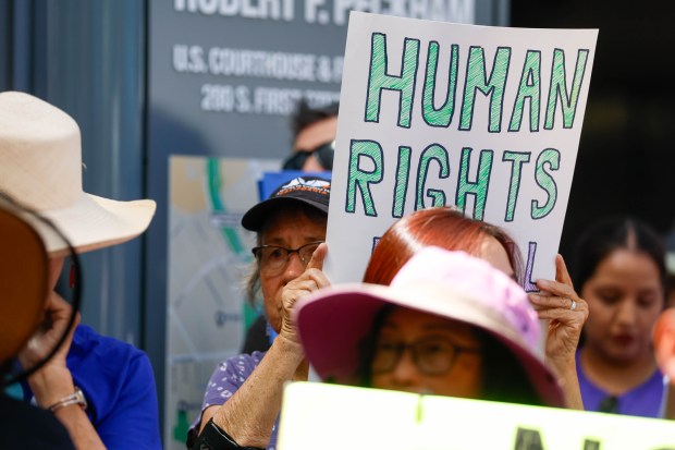 People hold signs during an press conference about an ICE center being built in Gilroy at the Federal Courthouse in San Jose, Calif., on Tuesday, Sept. 8, 2026. (Shae Hammond/Bay Area News Group)