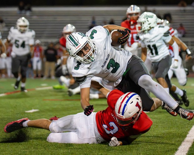 Pajaro Valley High's Adrian Valadez Jimenez is tackled by Independence's Jessiah Amaral during the teams' nonleague football game in San Jose on Friday. (Raul Ebio - Santa Cruz Sentinel)