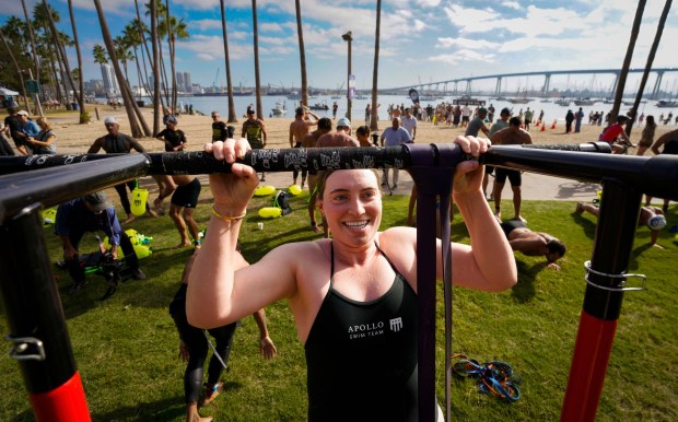 CORONADO, CA - SEPTEMBER 19, 2026: Reagan Roob of New York City, one of the participants in the 6th annual Swim for SOF ( Special Operations Forces), put on by the Honor Foundation, does pull-ups at Tidelands Park, during a stop on the way during the 3.2 mile swim from Glorietta Bay Park to the USS Midway Museum, Saturday September 19, 2026, in Coronado, California. (Howard Lipin / For The San Diego Union-Tribune)