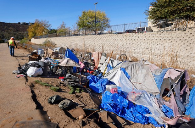 A homeless encampment lines the side of the Escondido Creek near Citracado Parkway in Escondido on Monday, Dec. 16, 2024. Escondido declared a local emergency over impacts from homeless encampments in the area after recent water quality tests showed elevated bacteria levels. (K.C. Alfred / The San Diego Union-Tribune)