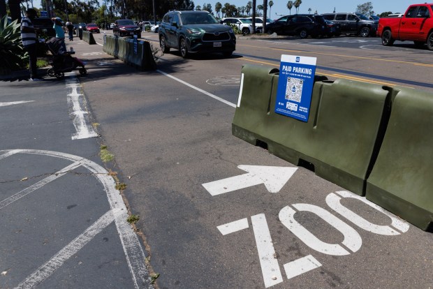 A paid parking sign with a QR code is displayed in the parking lot at the San Diego Zoo on July 23, 2026. (Kristian Carreon / The San Diego Union-Tribune)