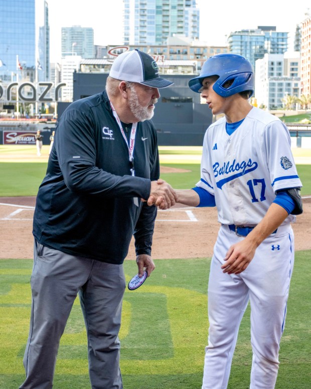 CIF San Diego Section commissioner Joe Heinz, left, awards Blake Hollopeter the 2025 John Baumgarten Mr. Baseball Award during a game at Petco Park. (Rich Koeberlein)