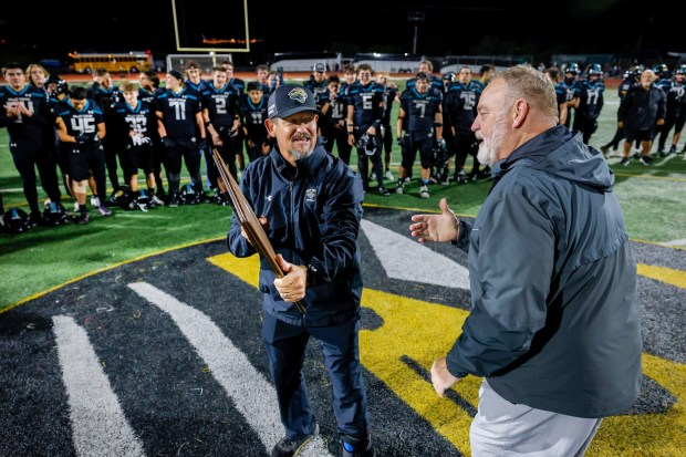 CIF San Diego Section commissioner Joe Heinz, right, congratulates Valley Center football coach Bill Dunckel following last year's championship game. (Charlie Neuman, for The San Diego Union-Tribune)