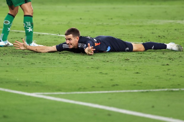 San Diego FC's Milan Iloski lies on the ground after a goal against Club America during their match at Snapdragon Stadium on June 7. (Meg McLaughlin / The San Diego Union-Tribune)