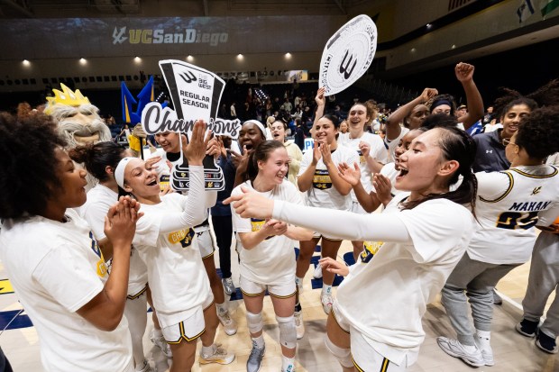 UC San Diego's women's basketball team celebrates after securing the Big West regular season championship in 2025. Credit: Derrick Tuskan/UC San Diego)