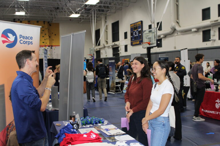 Sean Murphy speaks at a career fair at UC Berkeley while students listen at the booth