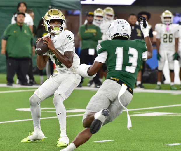 Long Beach Poly QB Donte Wright looks to pass under pressure vs. Inglewood in football game Friday September 18, 2026 at SoFi Stadium (Photo by Robert Casillas, Contributing Photographer)