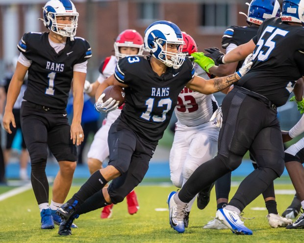 Madison Heights Lamphere's Peyton Archer (13) maneuvers through traffic Friday during this 59-8 Macomb Area Conference Gold Division win over St. Clair Shores Lake Shore on Sept. 18, 2026. (GEORGE SPITERI -- For MediaNews Group)