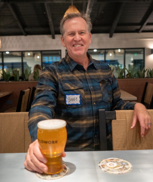 Barry Braden, owner and founder of Fieldwork Brewing Co., enjoys a pint at the soft opening of his new Montgomery Village location with friends and family on Friday, Nov. 21, 2025 in Santa Rosa. (Nicholas Vides / For The Press Democrat)