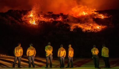 Firefighters watch as a wildfire called the Plaskett Fire burns towards Highway 1 on Friday, Aug. 28, 2026, in Big Sur, Calif.