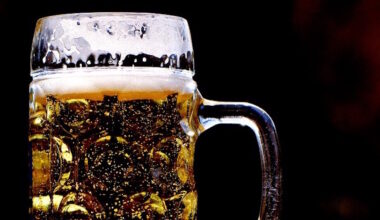 Cold pint of craft beer against a black background