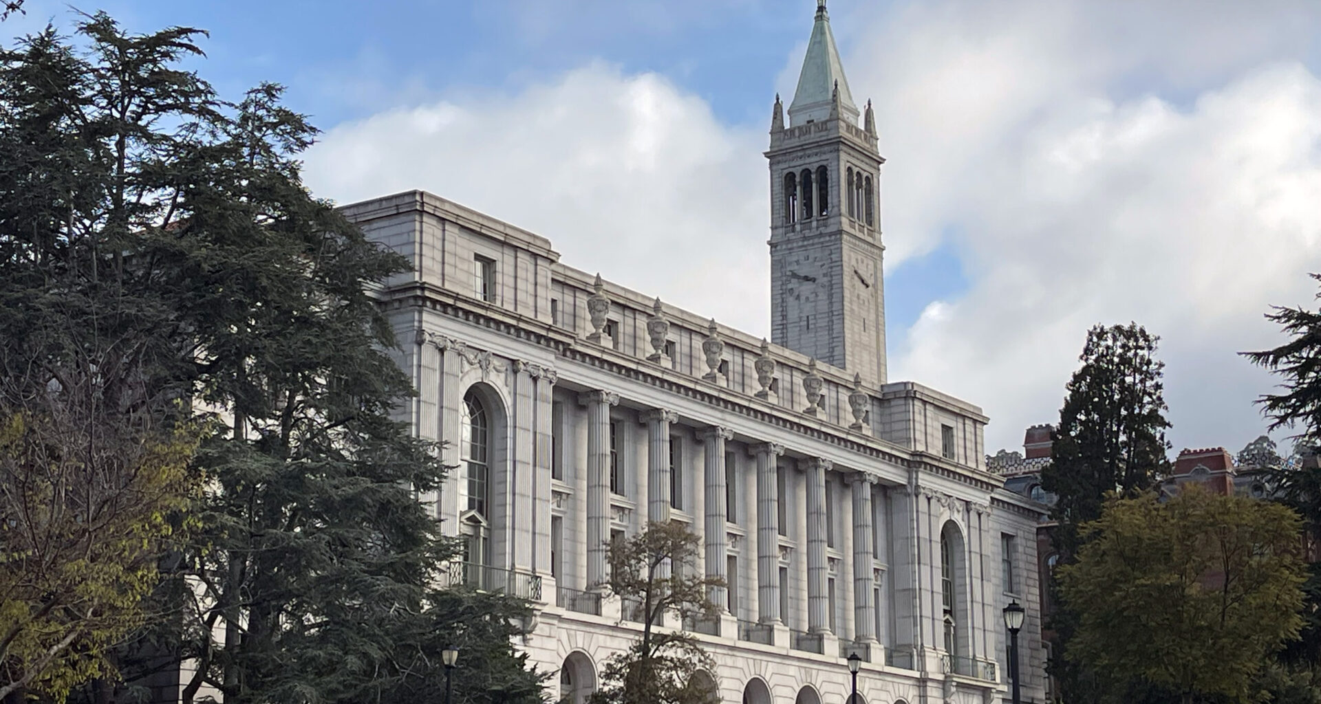 a classic building on the University of California, Berkeley, campus, with the Campanile towering in the background