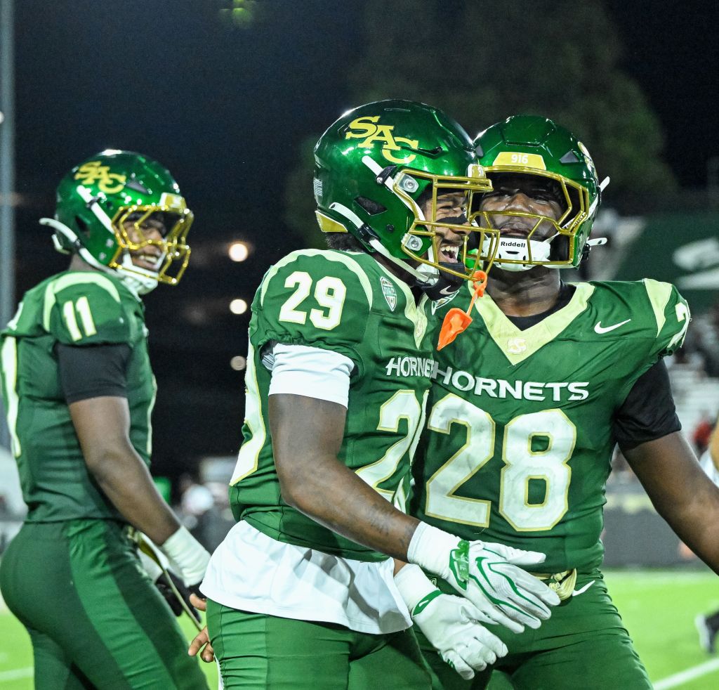 Sacramento State players Caleb Reese (29) and Jiah Walls (28) celebrate during a game.