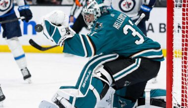 Connor Hellebuyck in a San Jose Sharks home uniform amid NHL trade rumors involving the Winnipeg Jets