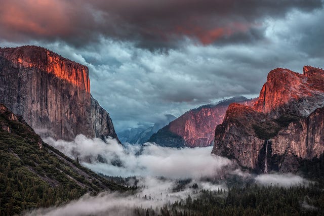 sunset over yosemite valley with mist and dramatic clouds sunset over yosemite valley with mist and dramatic clouds