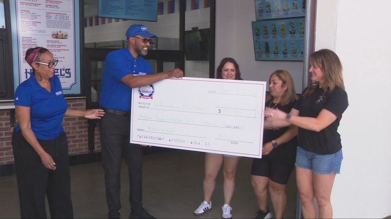 Handel’s on Panama Lane presented Independence High School’s colorguard and band boosters with a check of over $1,800 from a fundraiser to replace or repair equipment and instruments affected by the deadly football game shooting. PHOTO: KBAK/KBFX