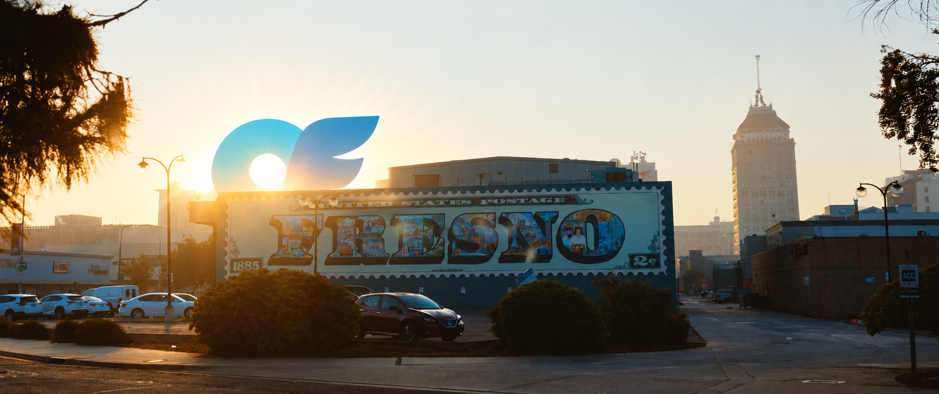 a building with a mural with sunrise and an only fans logo rising over the building
