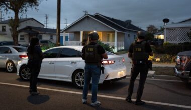 FBI agents take positions outside the home of Lakiya Malone, who is charged with fraud involving federal homelessness aid programs, in Los Angeles, Wednesday, Sept. 16, 2026. (AP Photo/Jae C. Hong)