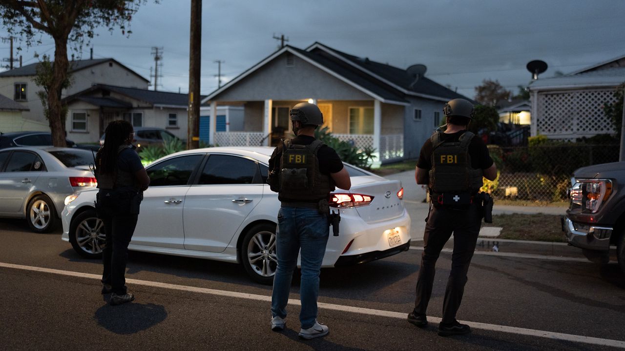 FBI agents take positions outside the home of Lakiya Malone, who is charged with fraud involving federal homelessness aid programs, in Los Angeles, Wednesday, Sept. 16, 2026. (AP Photo/Jae C. Hong)
