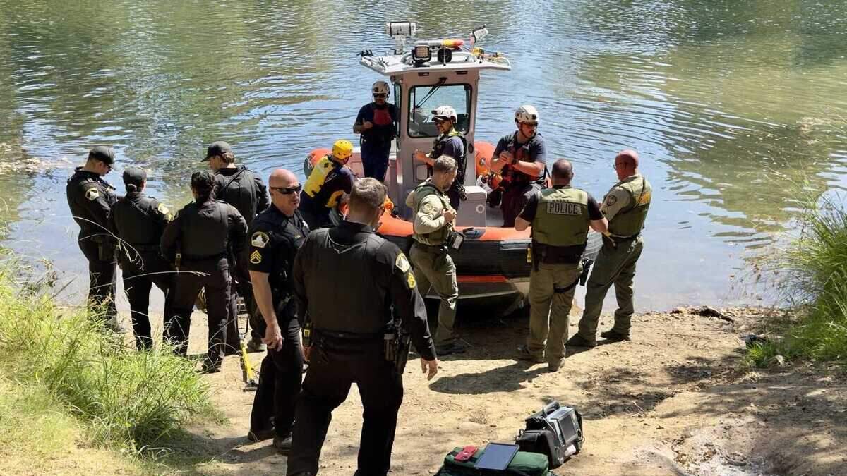 Sacramento Metropolitan Fire District personnel and Sacramento County sheriff’s deputies and park rangers gather along the American River near Estates Drive in Arden Arcade on Sunday, Sept. 13, 2026. A man was found submerged in the river and pronounced dead after firefighters pulled him from the water.