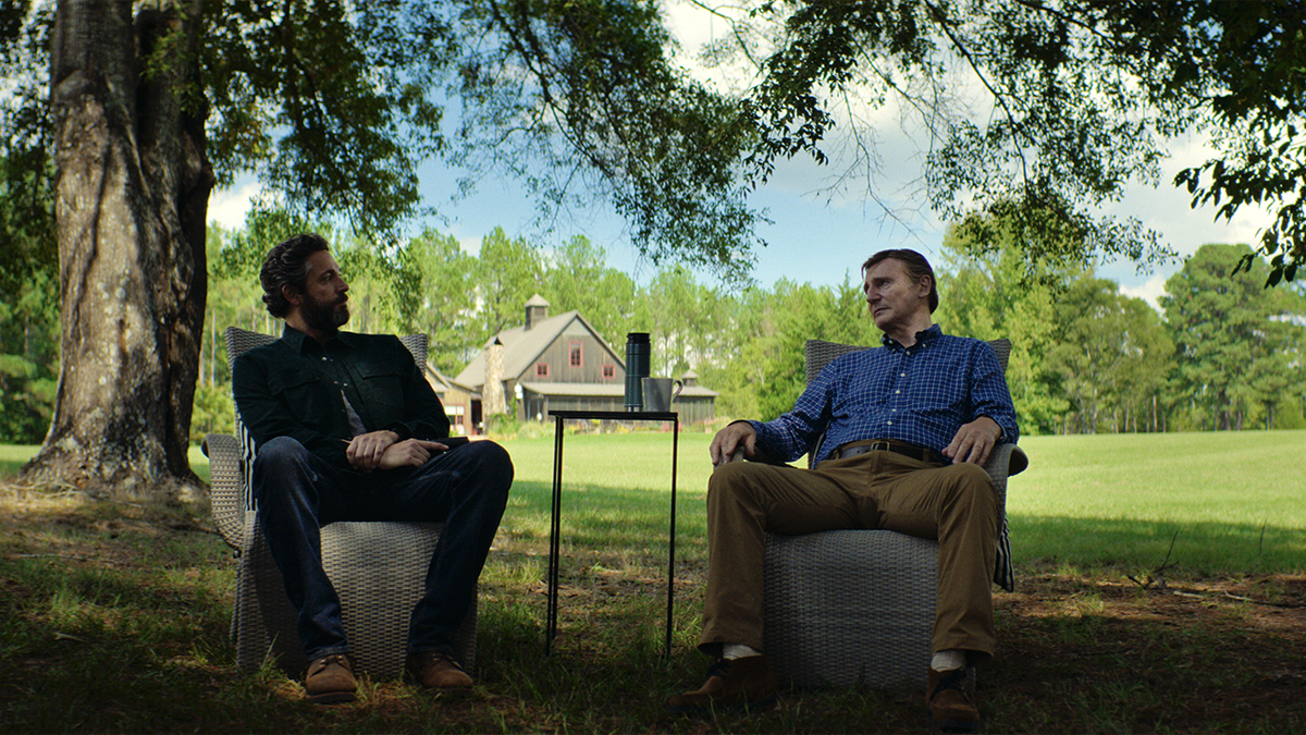 Liam Neeson and Zachary Levi talking in The Fix