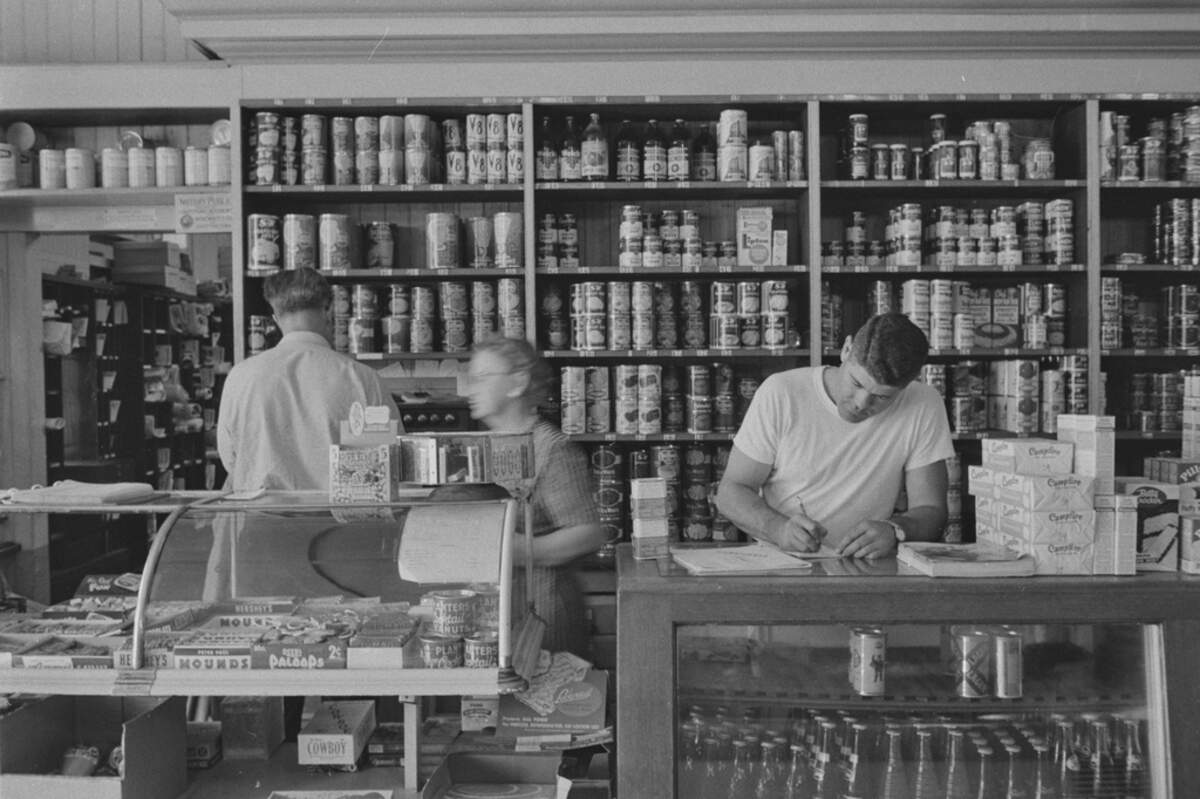 Workers at Cook, Mackenzie and Son — Monticello’s general store — in 1956.