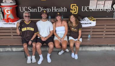 Family of four sitting in dugout at San Diego Padres game