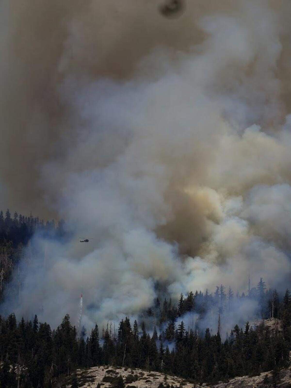 A helicopter can be seen battling the Dome Fire in Yosemite National Park.