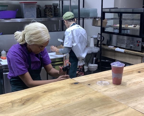 woman takes a picture of a drink