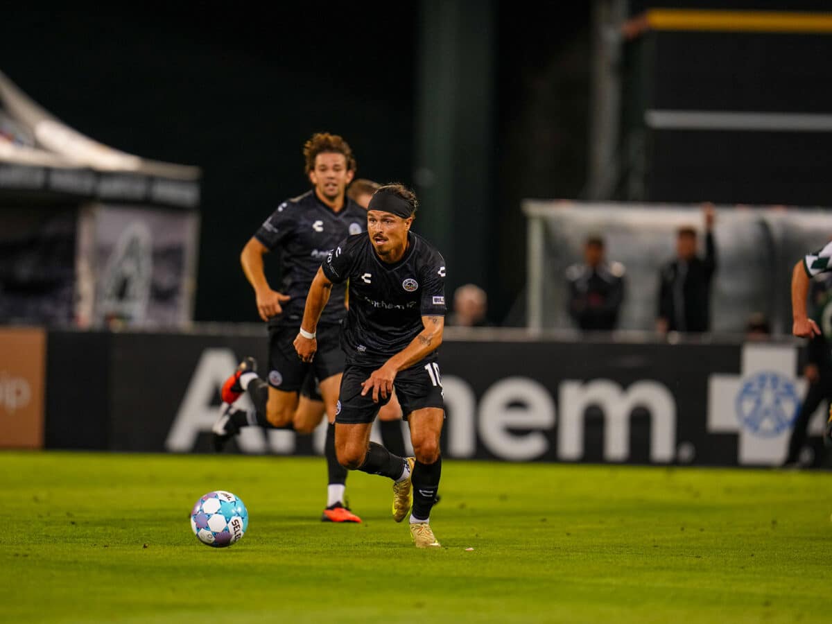 Alameda Post - Oakland Roots soccer playes with the ball
