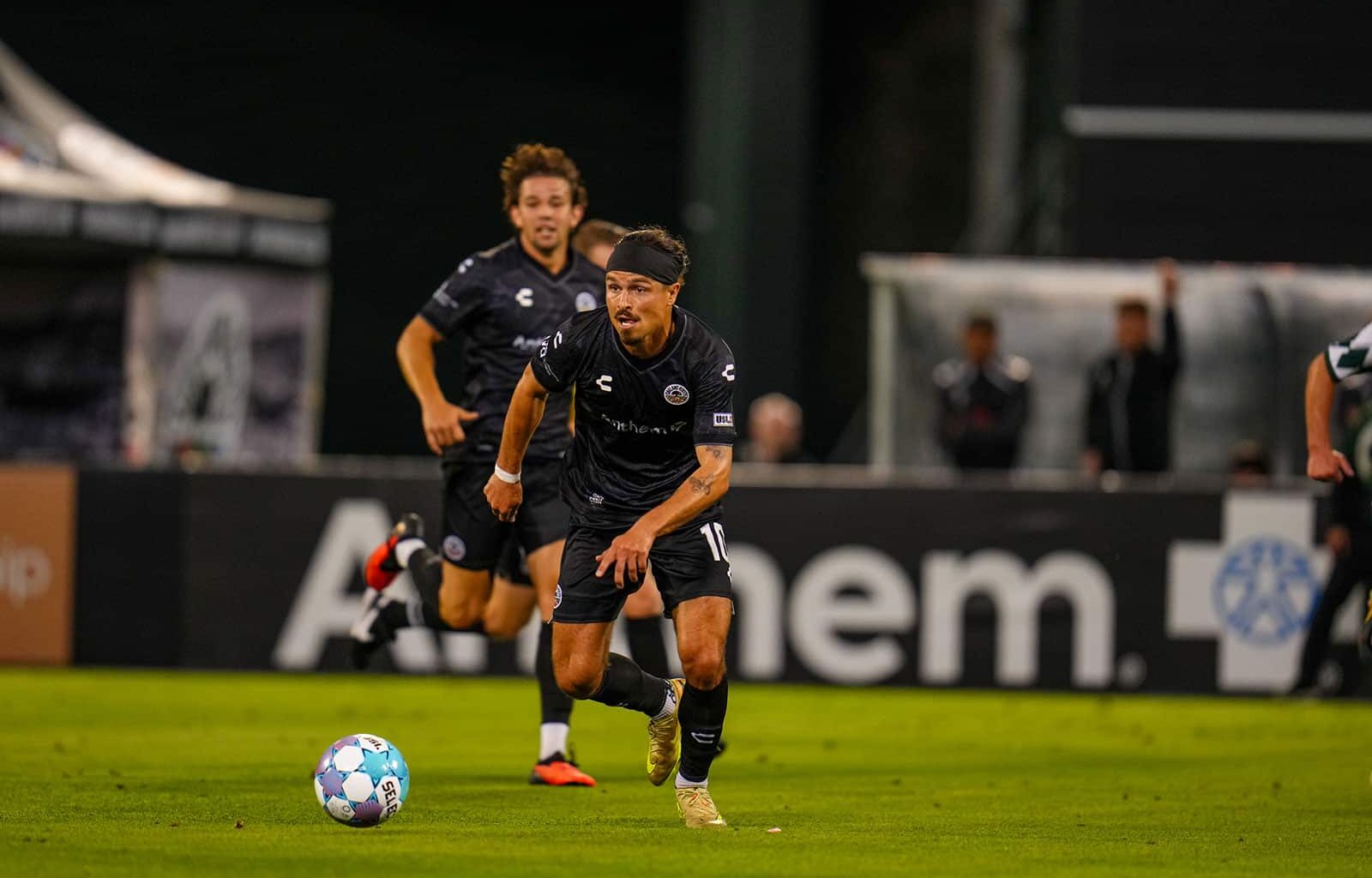 Alameda Post - Oakland Roots soccer playes with the ball