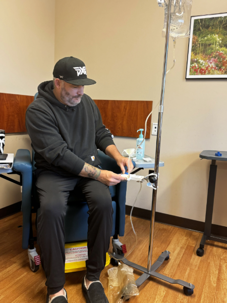 Man sitting in chair connecting to IV.