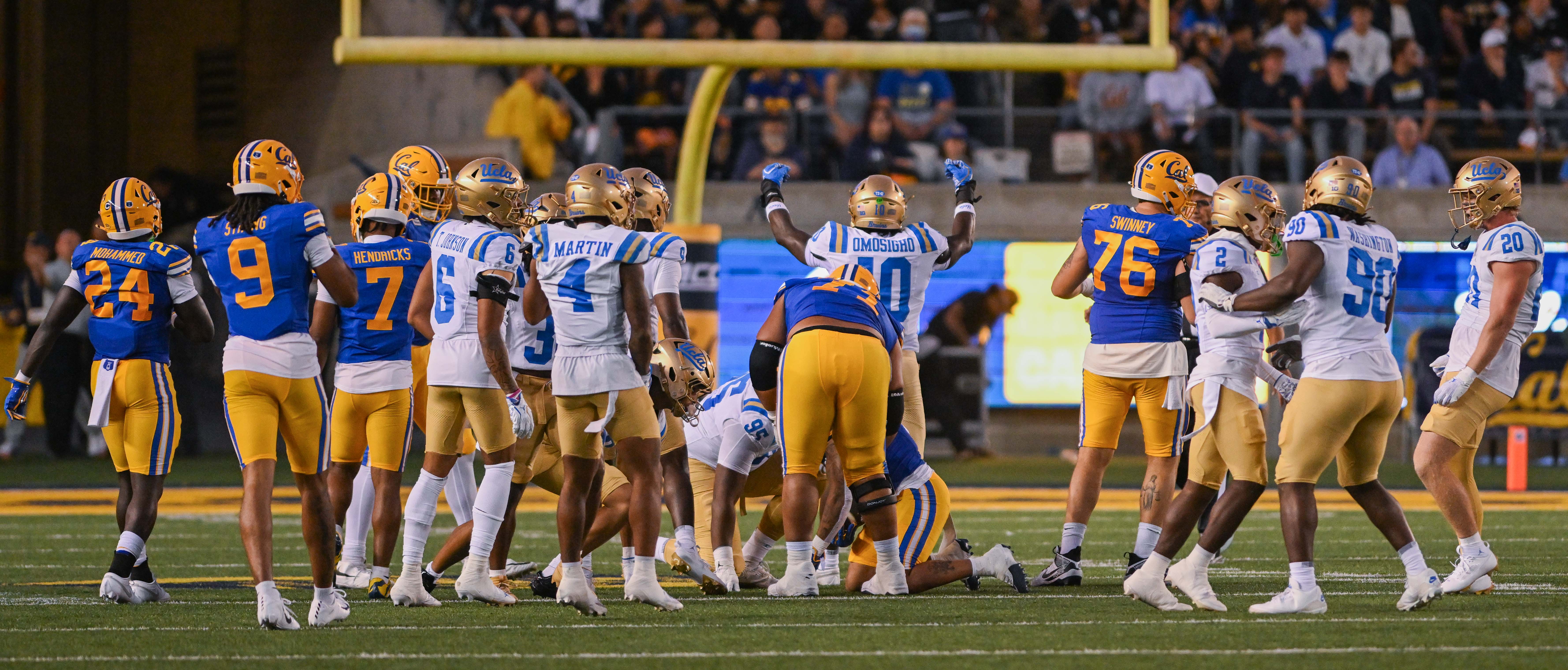 UCLA football senior linebacker Sammy Omosigho holds his arms up while facing the crowd during the team’s season opener against California on Saturday, Sept. 5, 2026, at California Memorial Stadium. (Presley Liu/Daily Bruin senior staff)