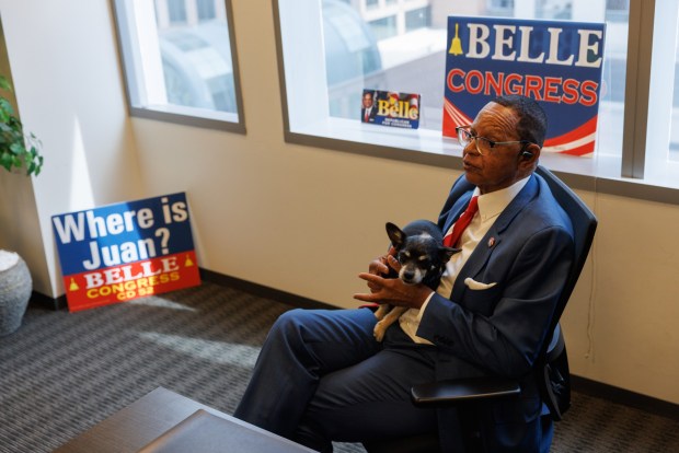 Congressional candidate Jeff Belle holds his dog Buster during an interview in his campaign office at One America Plaza in downtown San Diego on Thursday, Aug. 20, 2026. (Kristian Carreon / The San Diego Union-Tribune)